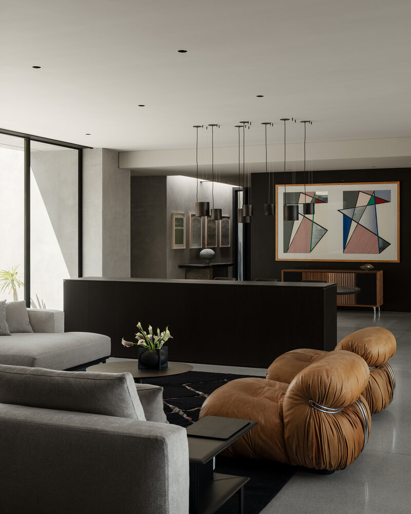 Modern kitchen with marble counters and wood cabinets designed by Palm Springs architect.
