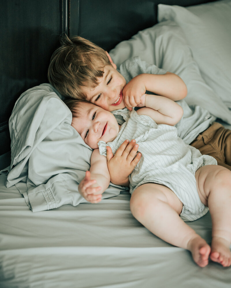 sibling toddlers in chair
