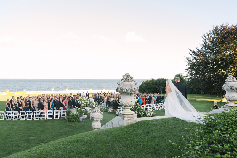 Bride walking down the aisle at Rosecliff Manor in Rhode Island, overlooking the ocean