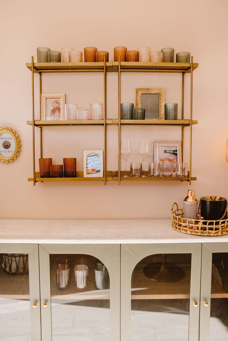 gold shelves on pink wall