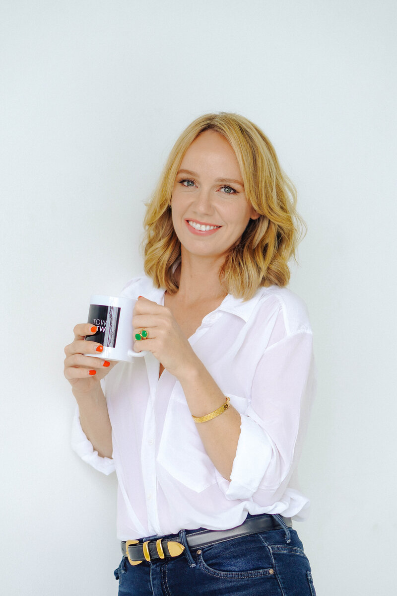woman smiling holding coffee cup
