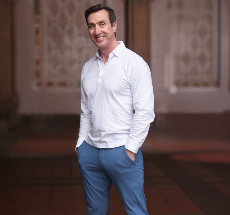 A relaxed portrait capturing personality and charm, featuring a confident smile and effortless style.