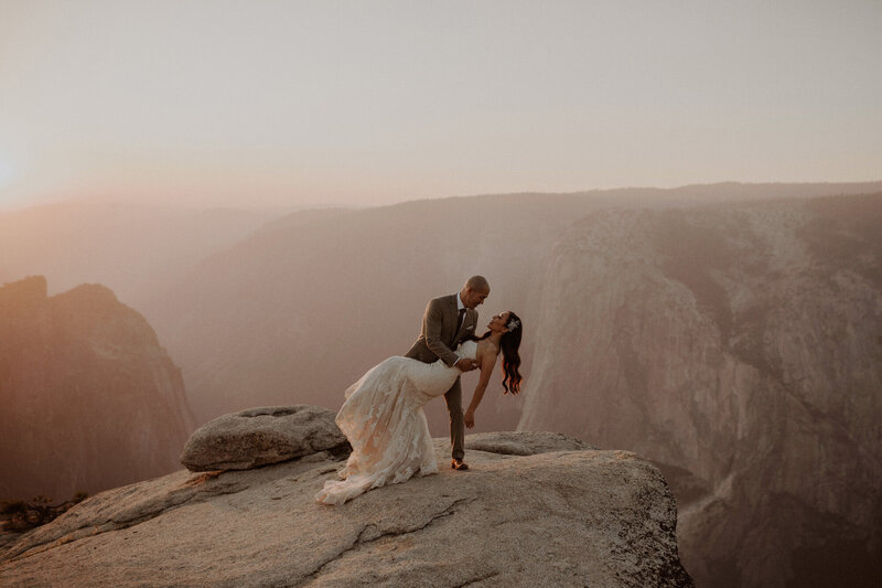 Groom dips bride at Taft Point in Yosemite