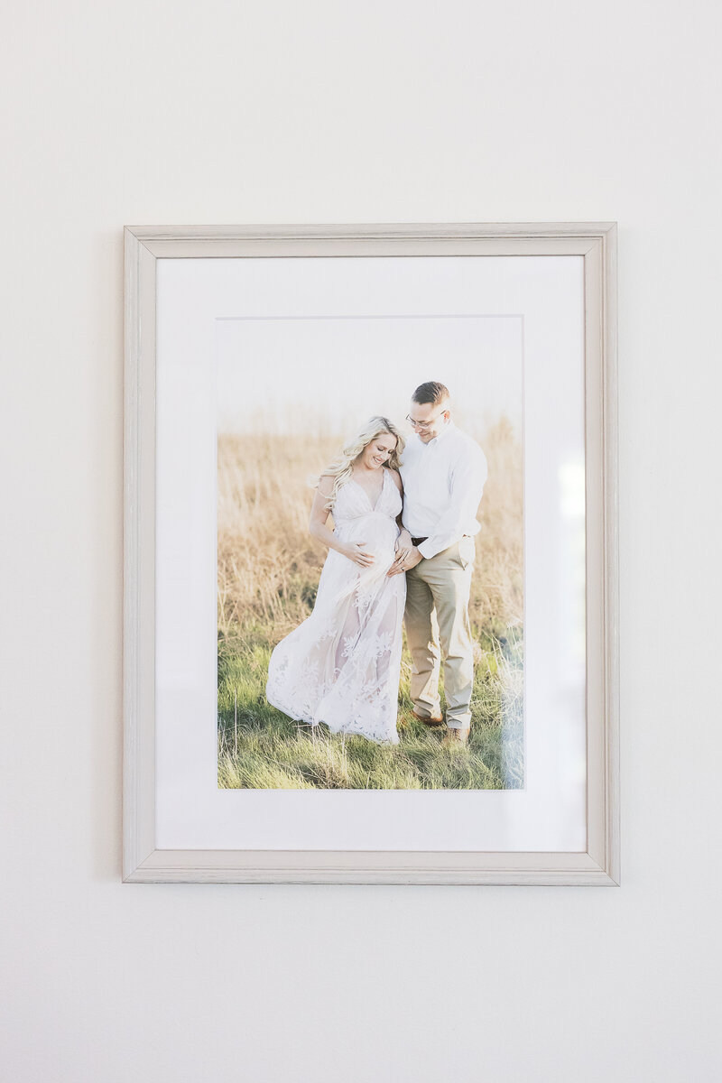 family portrait in neutral frame hanging on the wall