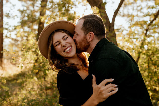 A man kissing a woman's cheek.