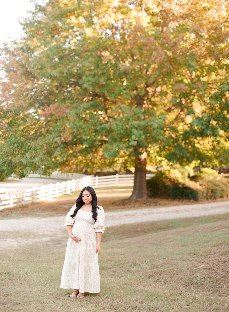 Photo of mom laying on a bed snuggling her newborn son Image by Raleigh newborn photographer A.J. Dunlap Photography.