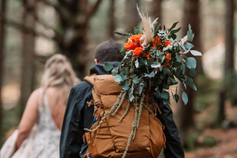 small wedding with multi colored flowers and a stormy background photographer