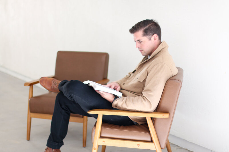 Man reading the bible in the church foyer - Restoration