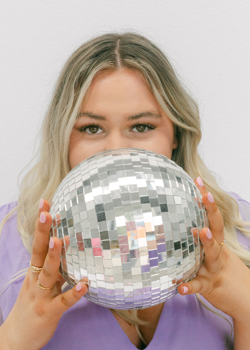 Disco ball covering face close up