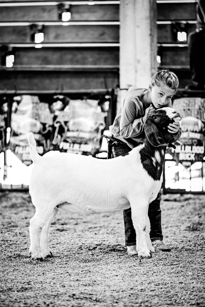 girl showing goat