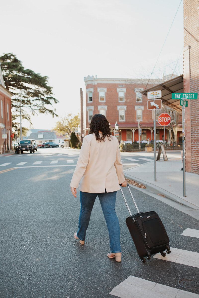Cassie Walking with a Suitcase