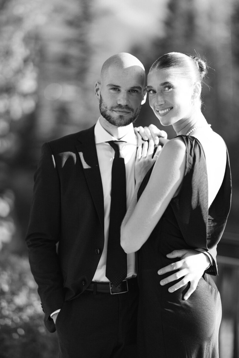 This captivating engagement photograph features a stunning couple looking into the camera during their shoot at the Malcolm Hotel in Canmore. Their striking looks and the beautiful setting create a powerful and memorable image that reflects their connection and love.