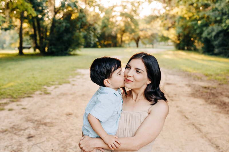 toddler boy kissing his mother taken by a Houston family photographer