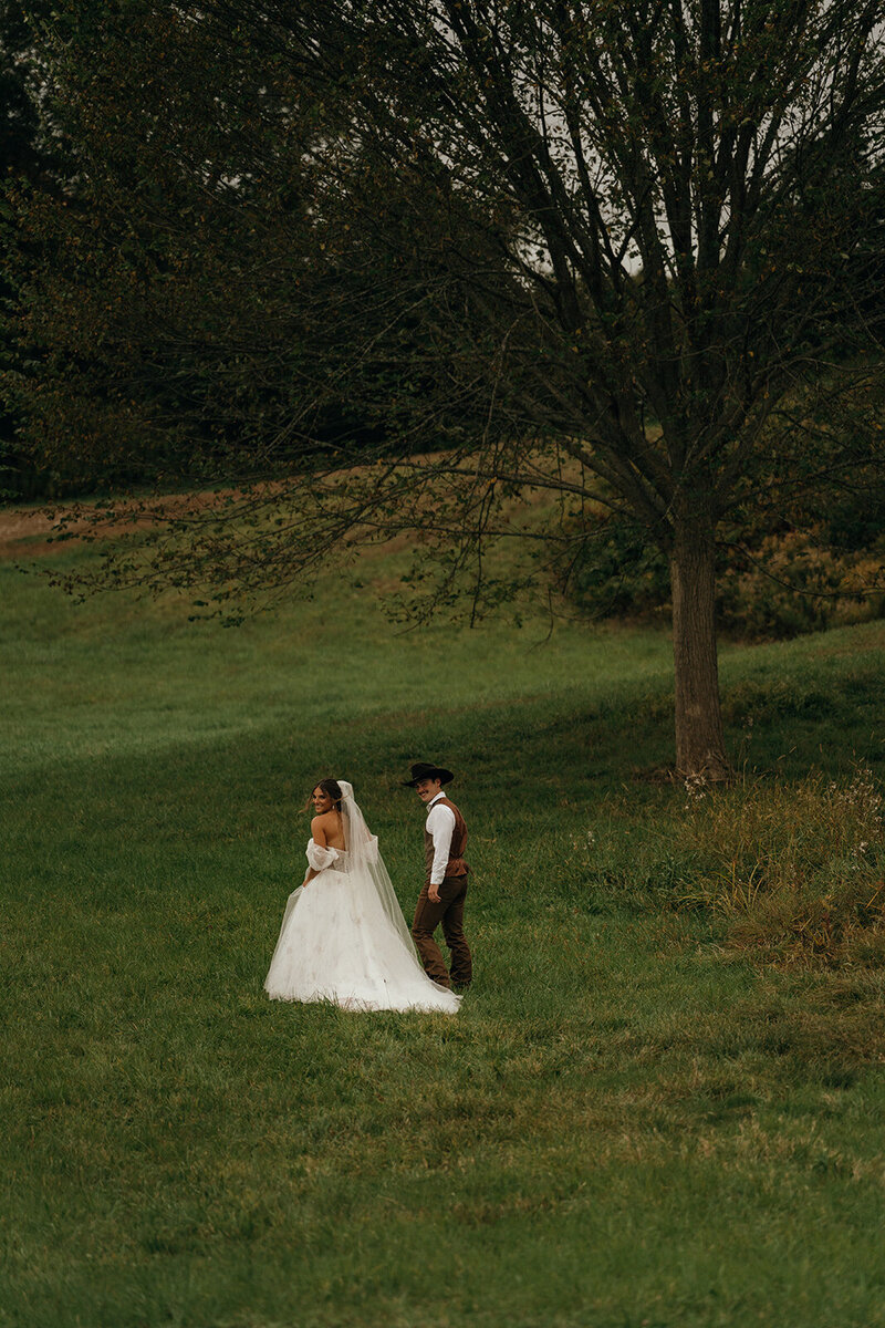 Rhode Island and Destination Wedding Photographer | Cinematic, Moody, Storytelling | Aisha Lee Photography | Bride and groom walking up a hill
