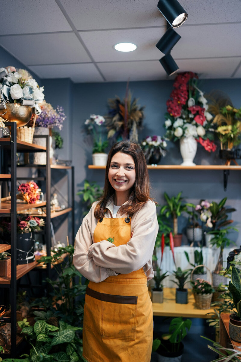 Business woman standing in front of her flower business