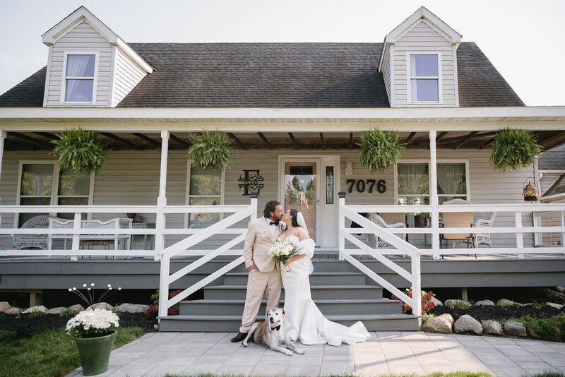 newly married couple in front of their home