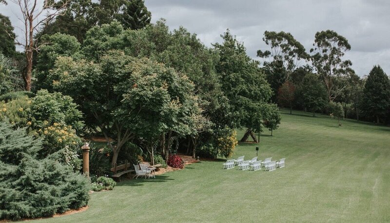 Arial shot of a wedding ceremony setup in a large grass area