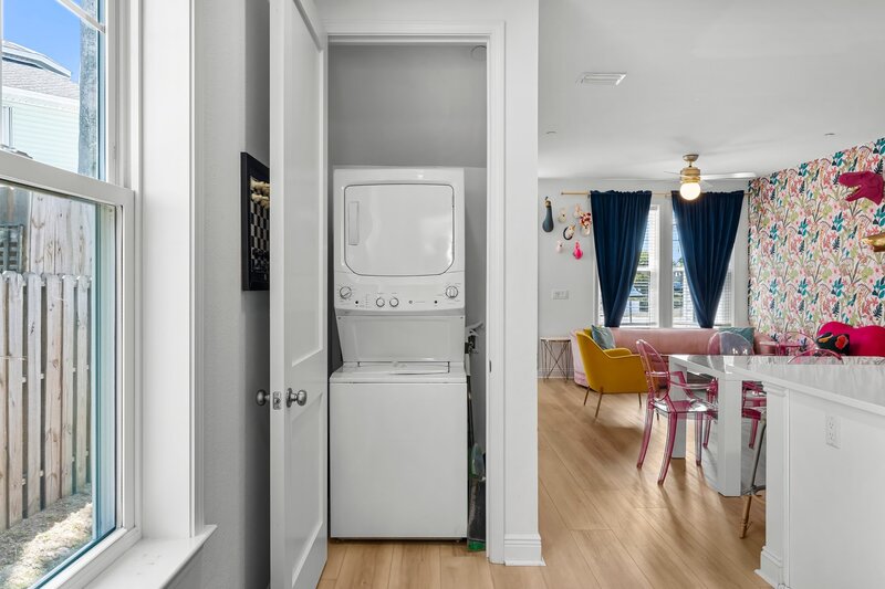 Convenient stacked washer and dryer tucked in hallway closet—perfect for extended stays or sandy beach days in Panama City Beach.