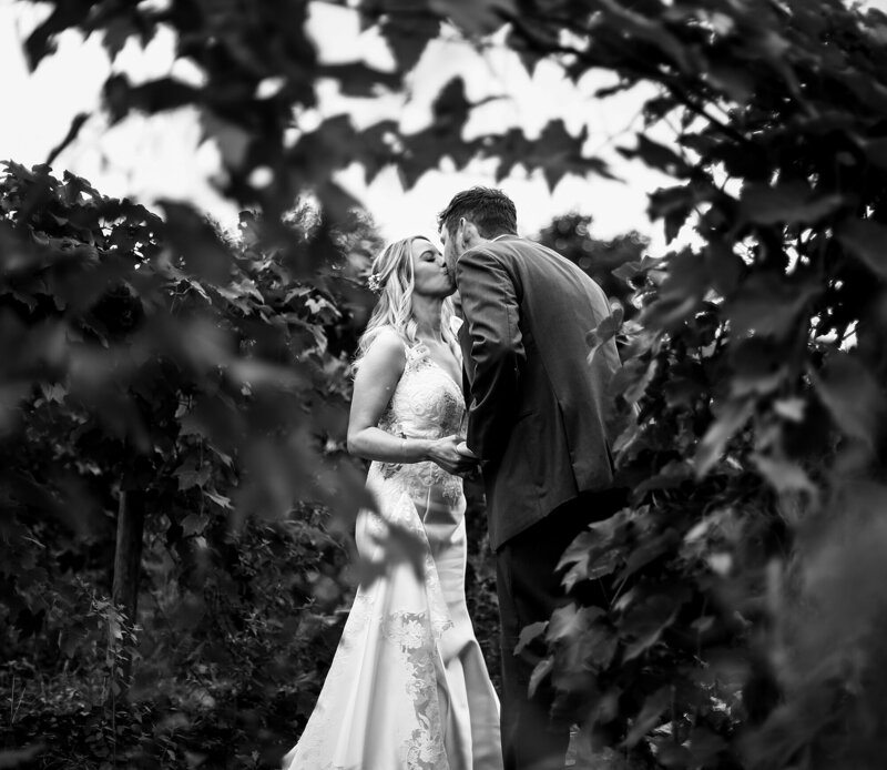bride and groom kiss under the marquee at the Warner Theatre in Erie, PA