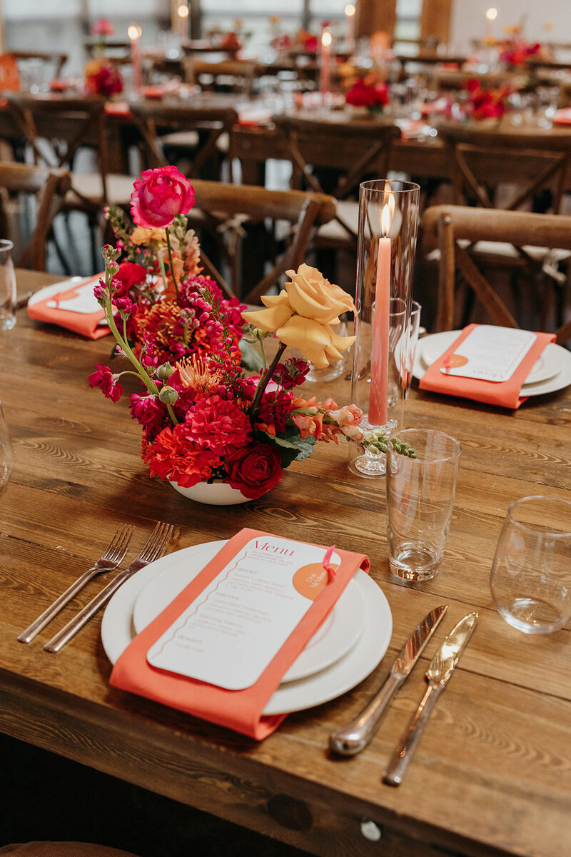 Small modern floral arrangements on long reception tables