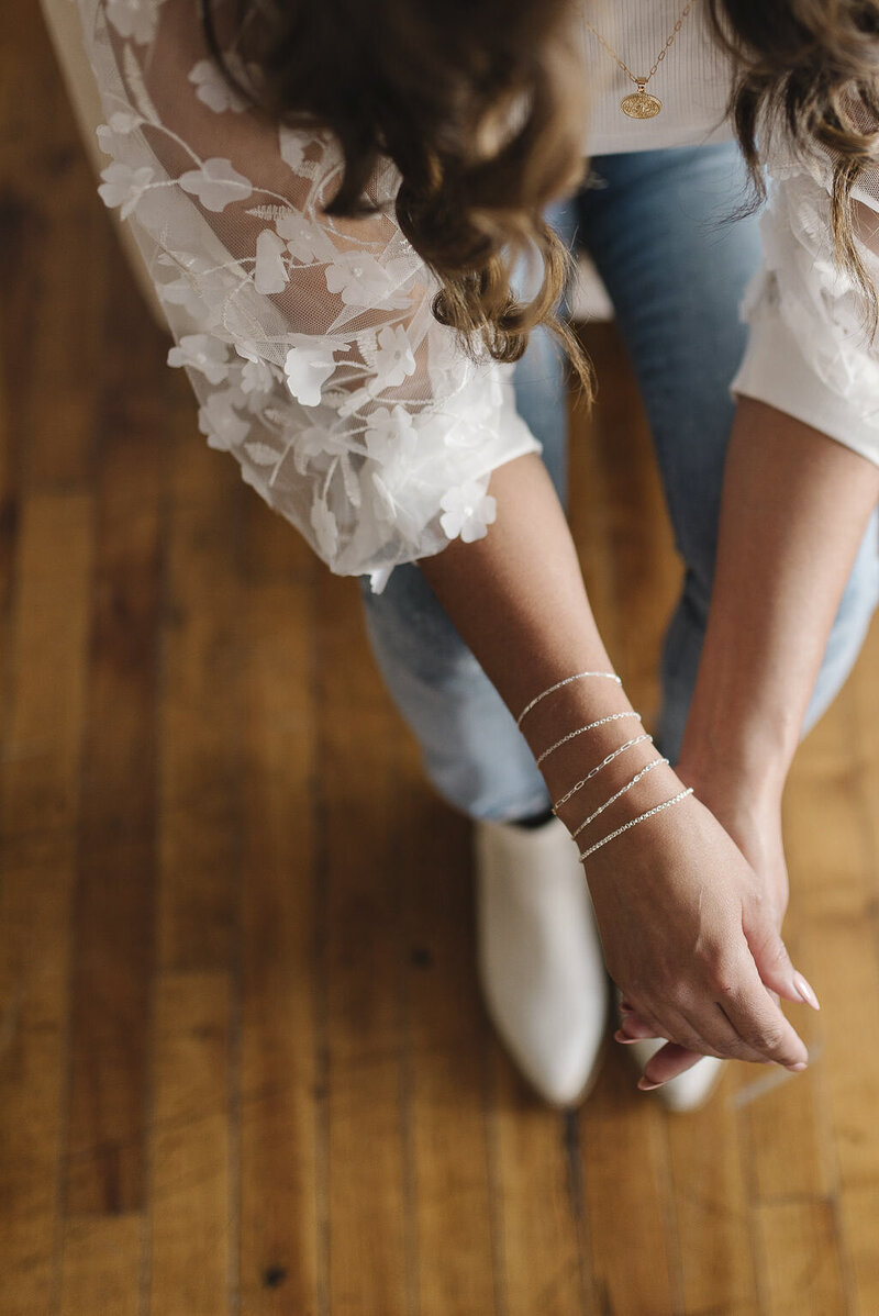 A woman dressed casually with jewelry