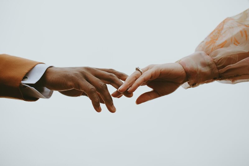 Bride and groom touch fingertios