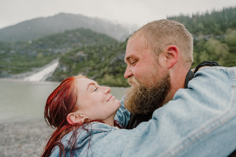 a married couple kissing middle of forest