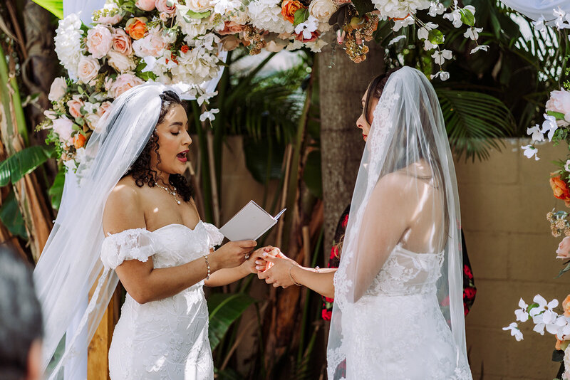 Brides celebrating after their St. Pete Beach wedding ceremony