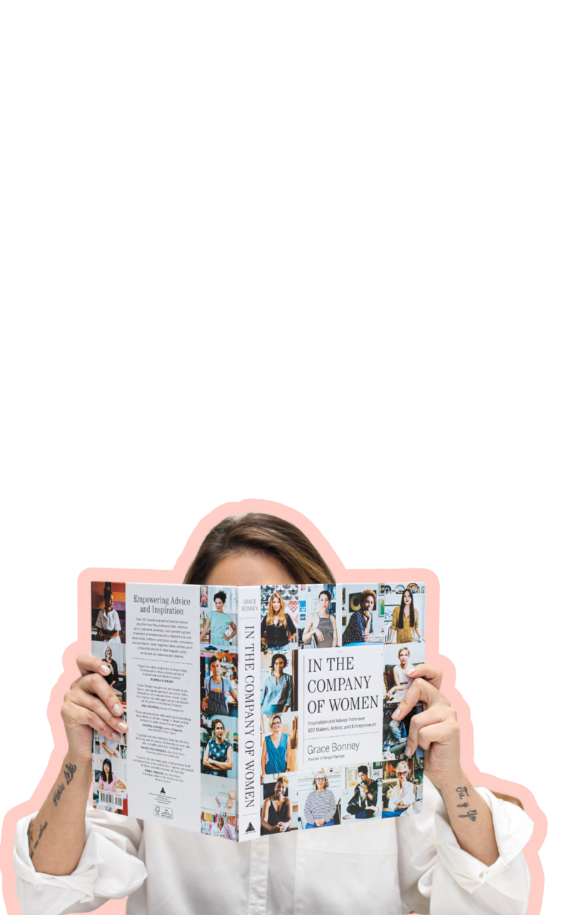 Latina-owned business expert holding her design book, empowering other Latina-owned businesses through intentional brand and website design services.