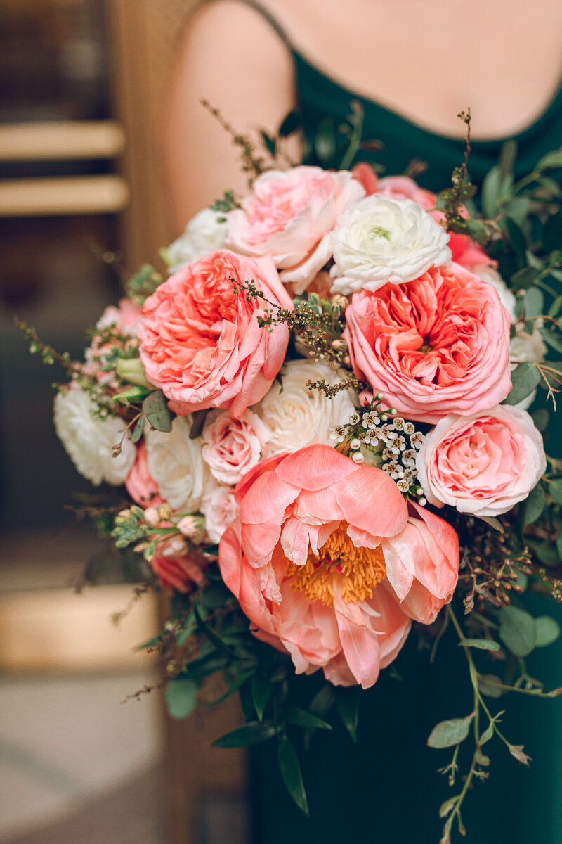 A bridesmaid holds a bright pink bouquet outside of the Lyric Opera in Chicago