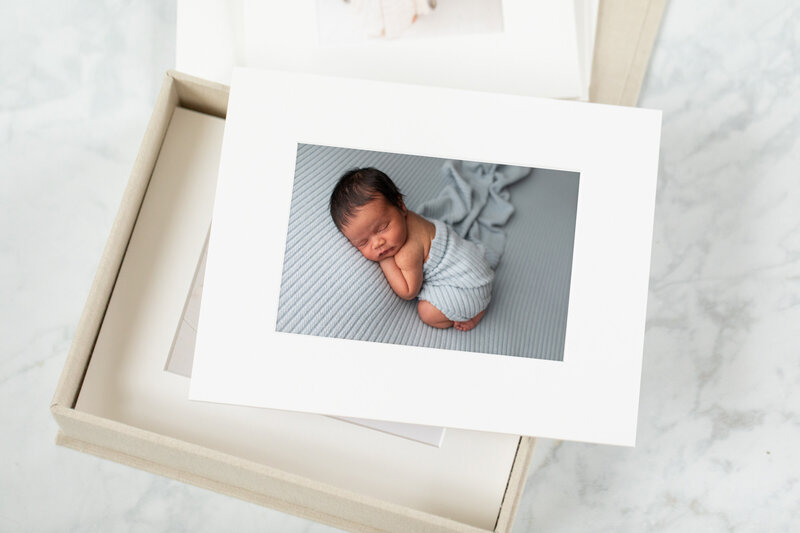 Matted Fine Art print of a newborn boy in blue  by Maryland Maternity Photographer : Rebecca Leigh Photography