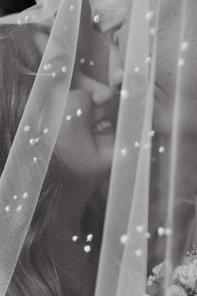 Portrait of modern bride in lace dress at race and religious wedding venue.