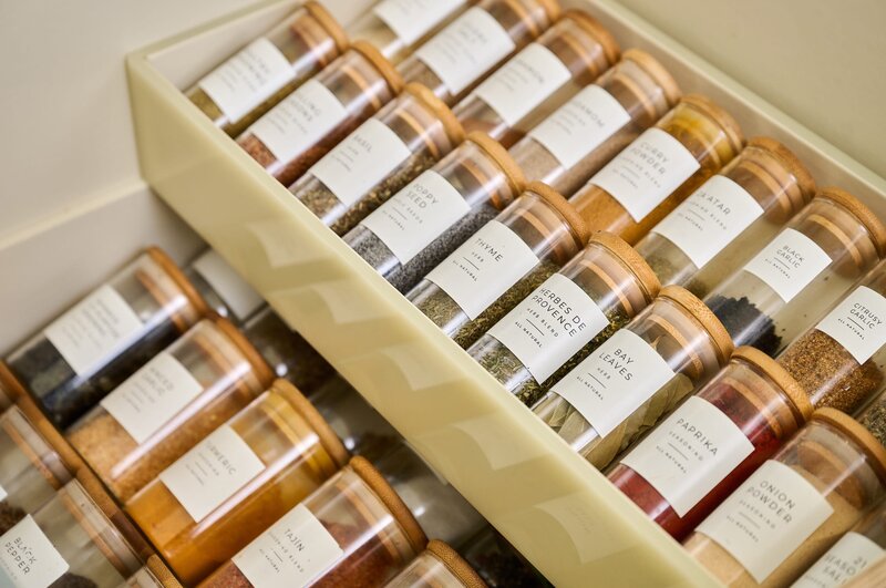 Organized spice drawer in glass containers