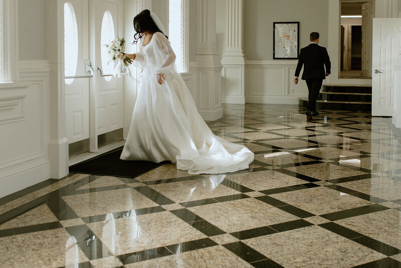 bride looks out window groom walks away