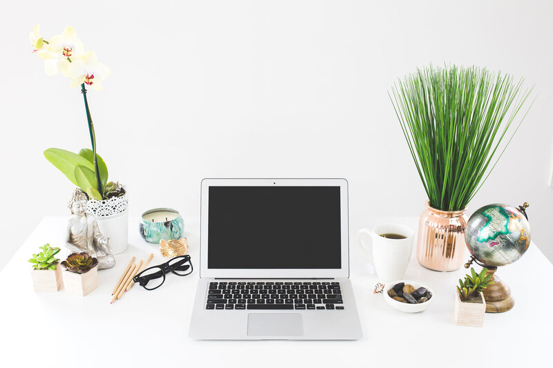 Desk with laptop, globe, and flowers