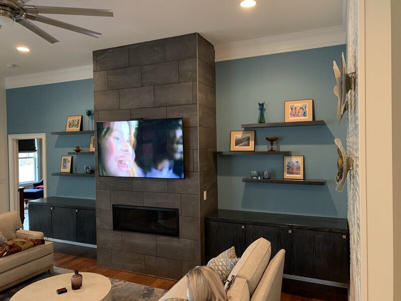 Living room floating shelves and cabinets