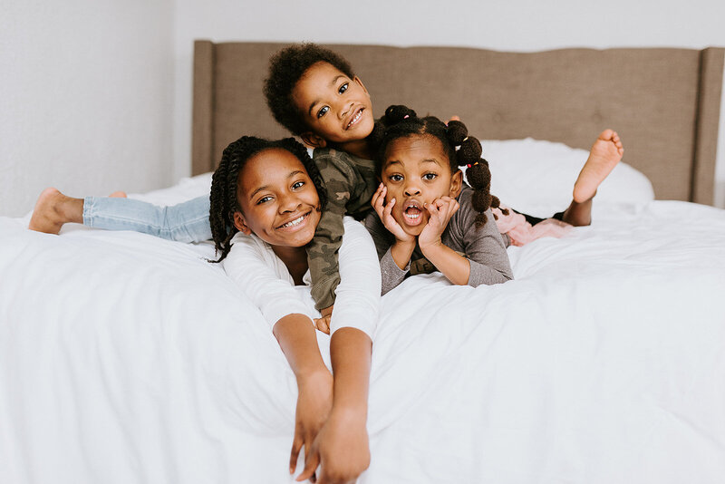 Children  snuggling for a modern in home family session.