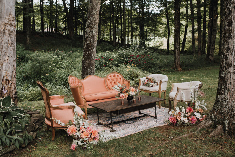 A peach and ivory vintage lounge at a woodland wedding venue in Roxbury, NY