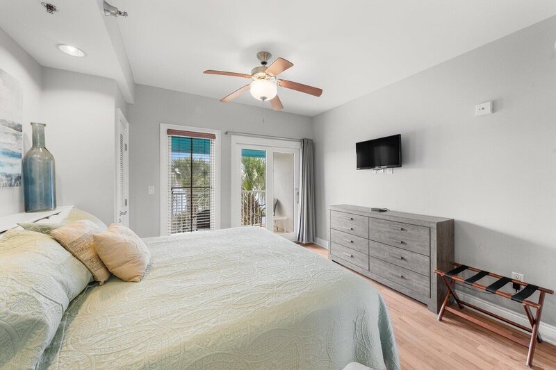 bedroom with king bed and grey dresser