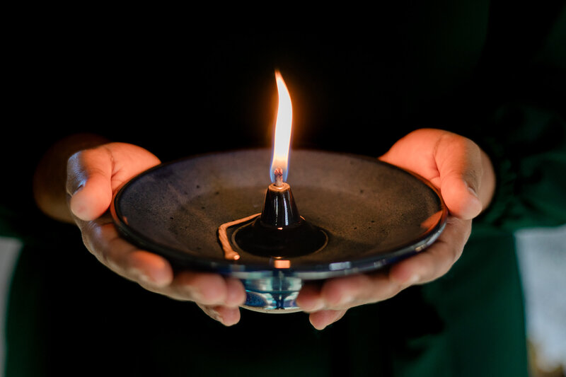 a man holding a lit candle