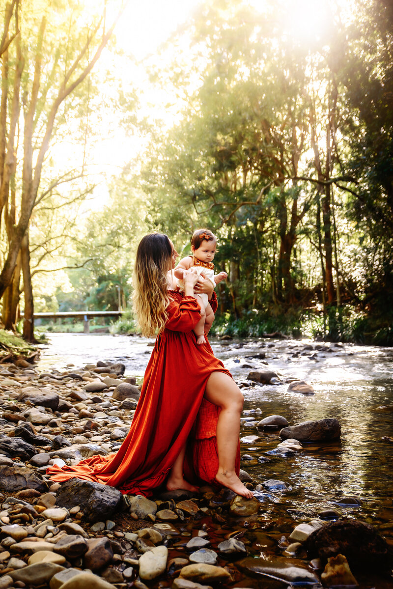 Nestled within the enchanting pine forests of Brisbanes glasshouse mountains this exquisite maternity photo by Paula Jane Photography captures the serene beauty of expectant motherhood. The expecting mother, surrounded by the towering pine trees and her family, radiates a sense of tranquility and anticipation. The soft sunlight filtering through the forest canopy adds a touch of magic to this timeless moment. Immerse yourself in the natural beauty of Brisbane's pine forests and let us create art that tells the story of your unique journey toward motherhood. Contact us to schedule your personalised maternity session with Paula Jane Photography