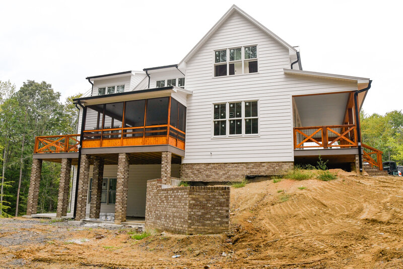 Farmhouse custom home screened porch white siding exterior