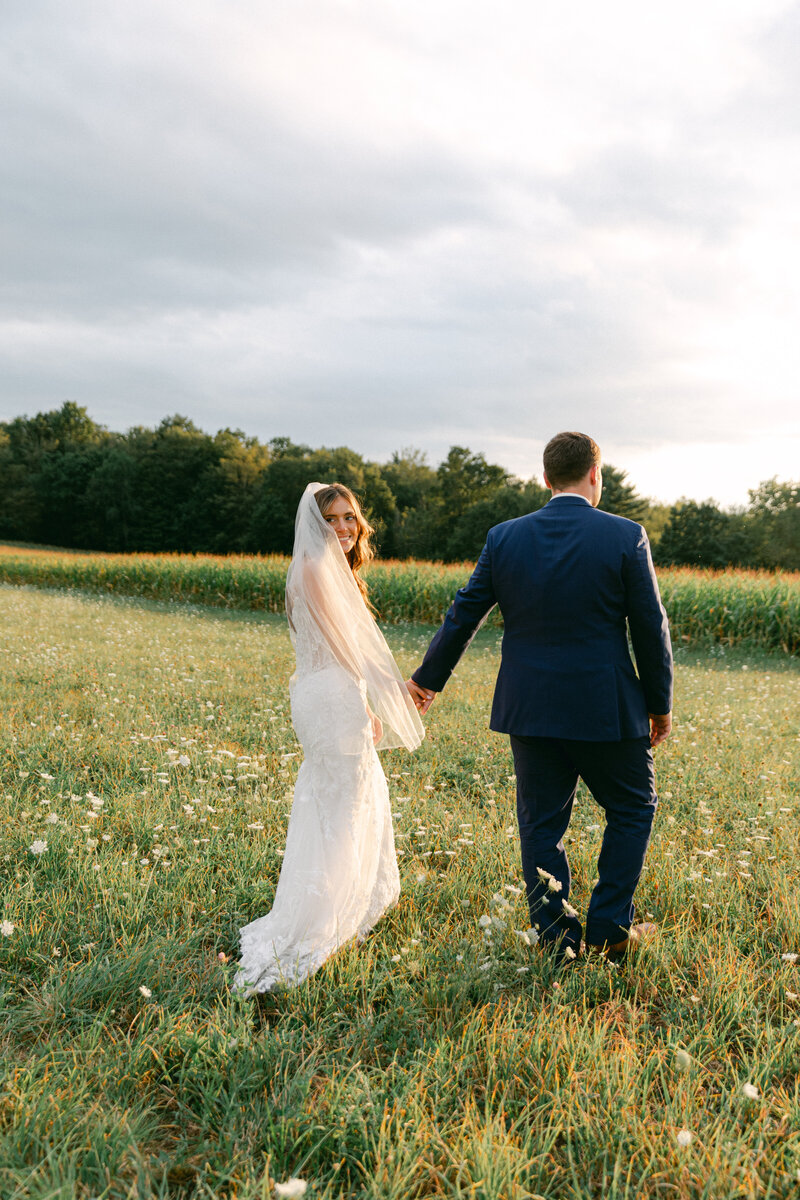 bride-groom-holding-hands-smiling-sunset