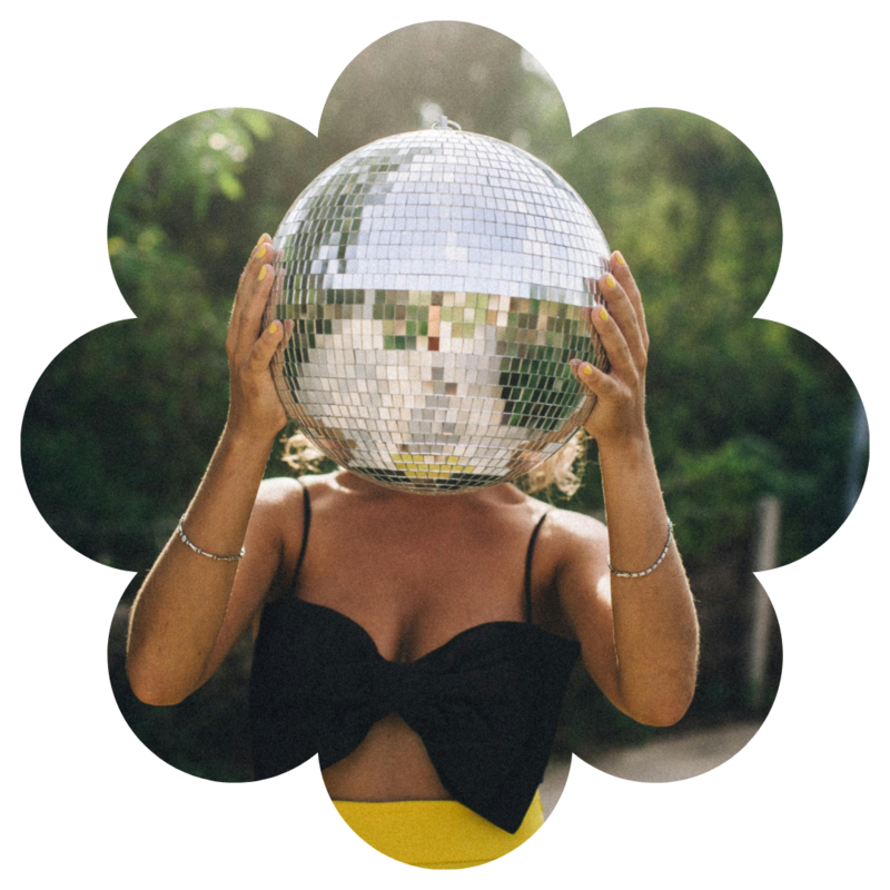 Girl holds disco ball over face