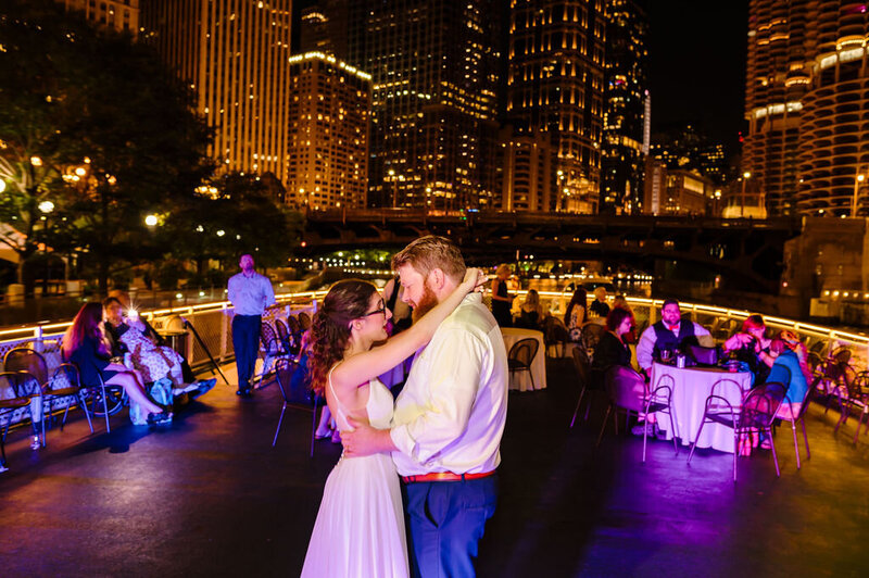 Bride and groom dance surrounded by the Chicago skyline on Chicago's First Lady Cruise.