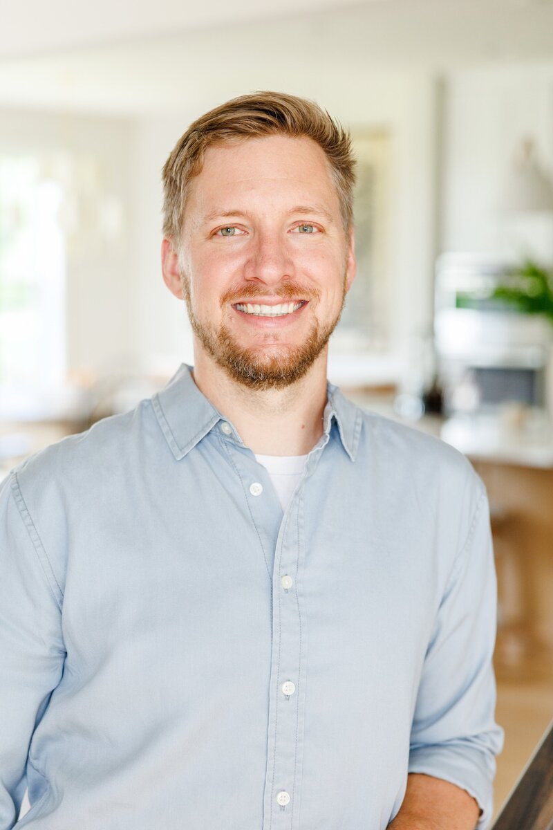 headshot of Adam smiling