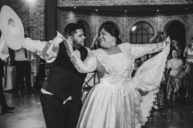 A joyful moment from a wedding celebration in Andover Township, NJ, featuring a couple dancing at The Refinery, embracing love and tradition in a timeless black-and-white shot.