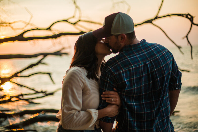 Couple kissing as the sun sets at Erie Bluffs State Park