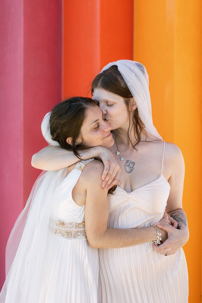 LGBTQIA couple embraces on their wedding day