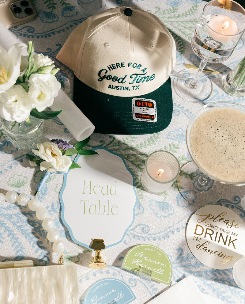 Modern wedding table decor featuring neutral floral centerpiece, crystal glassware, romantic candlelight, and wood table number sign, styled by Eventive Designs.